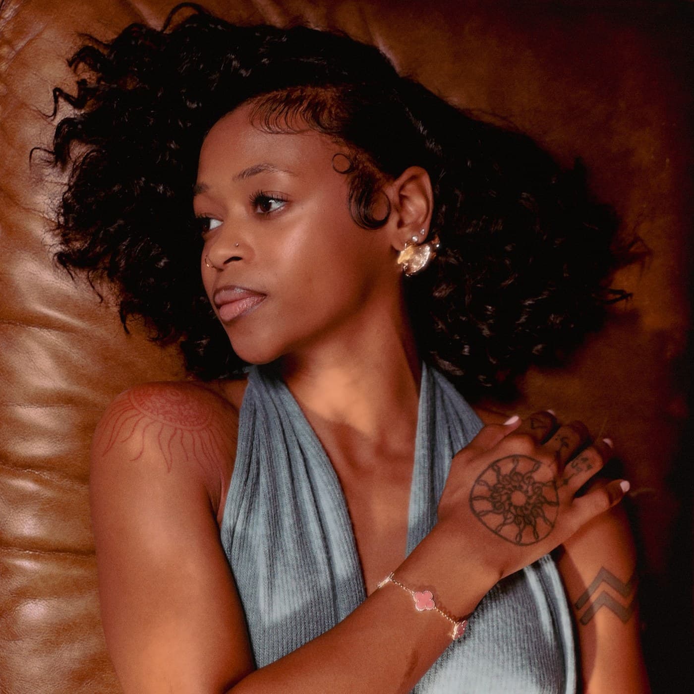 Jastin Martin lying against a leather couch
